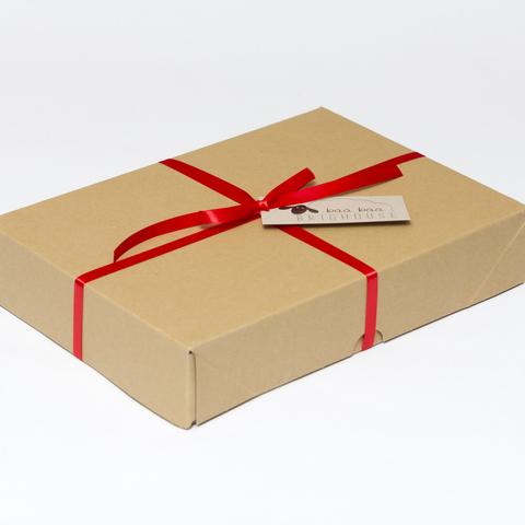 Picture shows a closed A4 box tied with red ribbon.