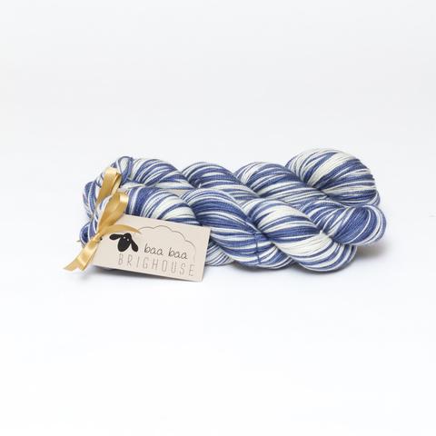 Picture shows two skeins of yarn, one behind the other, in shades of blue and white.