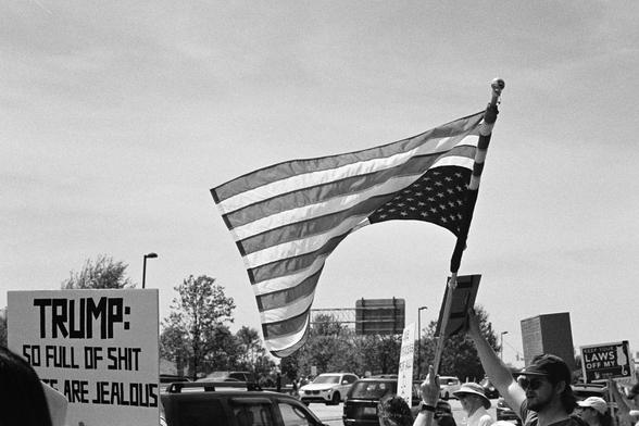 An American flag being flown upside down, a symbol that the country is in danger