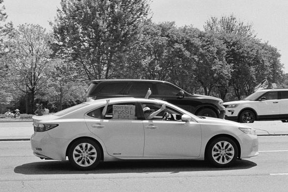 A car full of well-wishing passers by with a sign “don’t be a fossil fool”