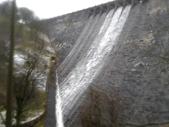 An image of the dam from the side, you can still see water falling