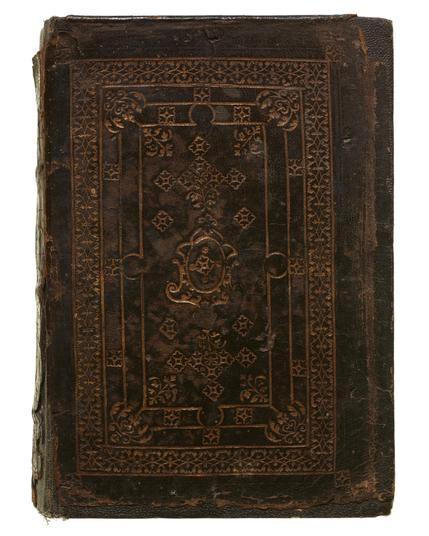 Dark brown leather cover of the book featuring gold tooling.