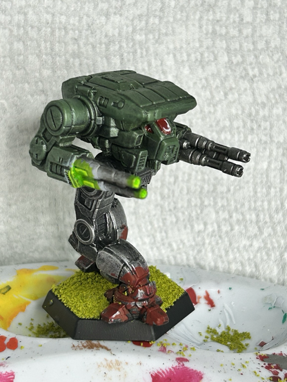 a Warhawk mech, green torso with metal legs, red paint splashed on the feet