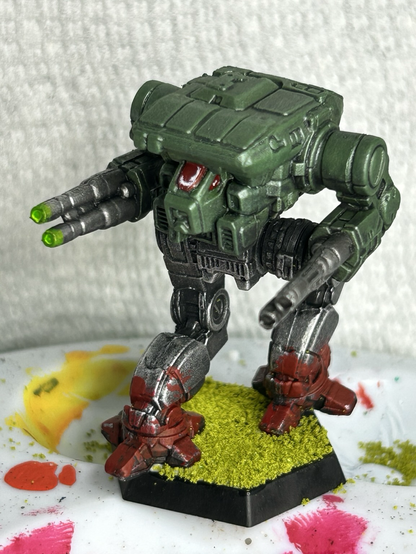 a Warhawk mech, green torso with metal legs, red paint splashed on the feet