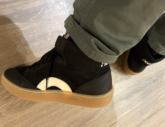 Picture of Nooch shoes (The ‘269’ Hi Black), with brown PLIANT™ outsole and white arch on black Canvas and vegan leather.