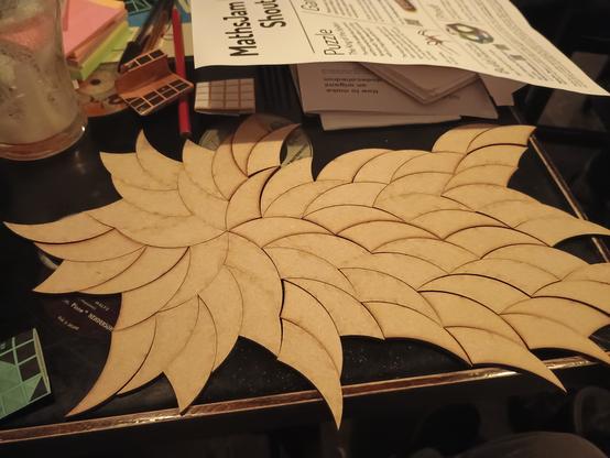 Curved triangular tiles arranged in a six sided spiral on a pub table.