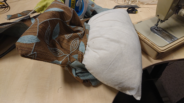 the cushion filling half-stuffed into the cushion case