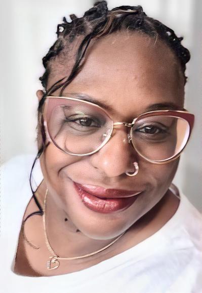 Color headshot photo of author R.J. Joseph, a Black woman with black hair in twisted braids. She wears a white crewneck top, a diamond-studded gold heart pendant on a necklace chain, a gold nose ring, large gold-rimmed cat-eye glasses, and burnished makeup with glossy lips. She smiles warmly at the camera, one long ringlet trailing along one side of her face.