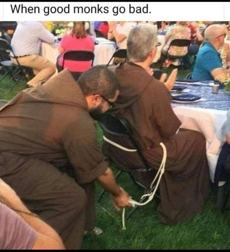 Photo of two monks, seated in small folding chairs on some grass, one behind the other. The one in the rear is bending forward and holding some of the rope used to tie the other monk's robe shut as a belt. It appears he is trying to tie it around the back of the chair. Meme text reads, "When good monks go bad."