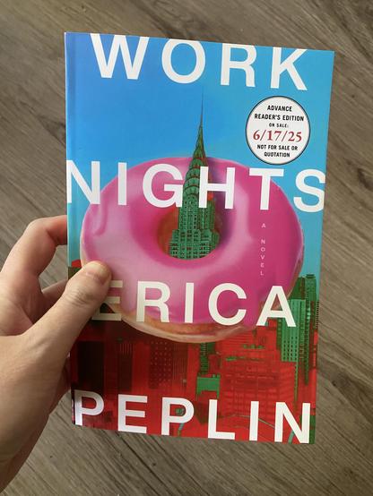 Hand holding book: Work Nights by Erica Peplin