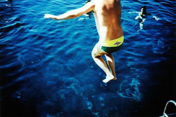 The very moment before a man gets to splashing in the bluest Sicilian Mediterranean sea. Taken on analogue 35mm expired & xproed Agfa CT Precisa film using a Lomography Lc-a vintage camera.