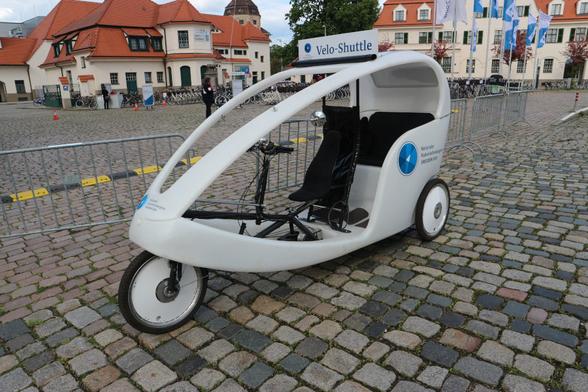 zu sehen ist eine Fahrradrikscha mit drei Rädern und Teilüberdachung.