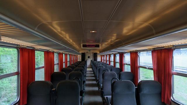 Inside empty Z2, old fabric seats and red curtains