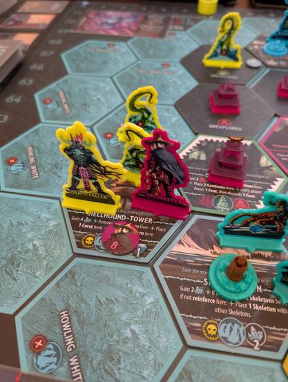 Closeup picture of Uprising: Curse of the Last Emperor on the table. Horde enemy Oda the Fallen is fighting a battle with the Legion enemy Spymaster in a Sea Tower hex.