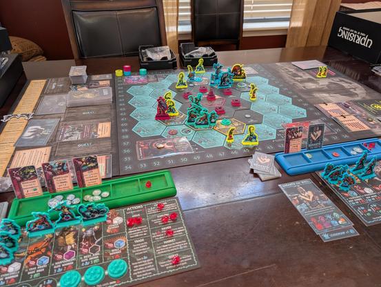 Full table picture of a early to mid game Uprising Curse of the Last Emperor. Picture shows the map, pieces, and the player boards and off-map components.