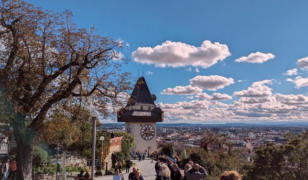 The clocktower of Graz with the city in the background.
