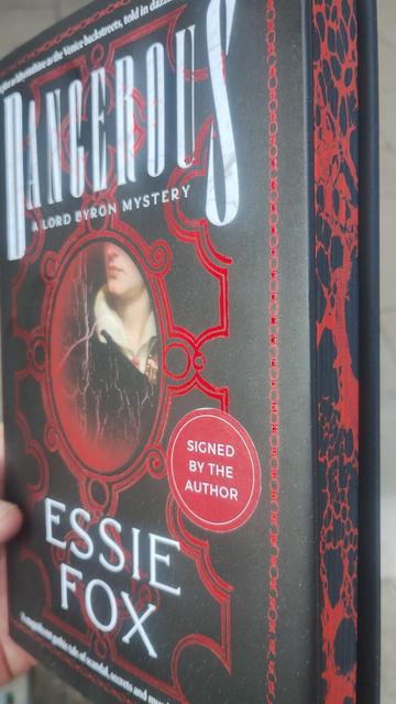 Side on view of the same book, this time angled to show off the psredges (sprayed, painted page edges) in black and red