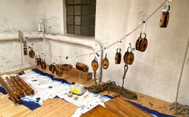 Frisch gestrichene Holzteile zum Trocknen an einem Tau aufgehängt.