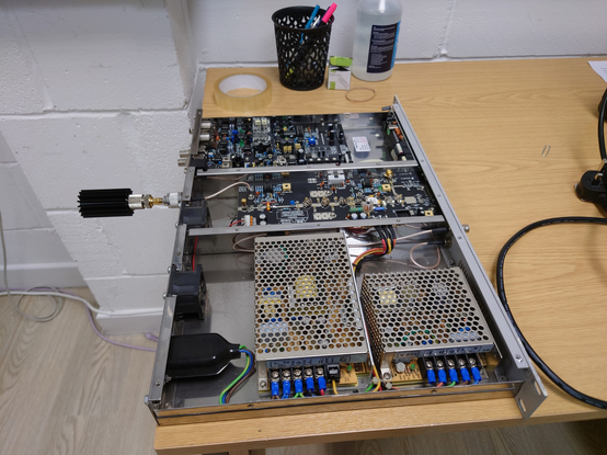 Broadcast Warehouse TX50 on a desk at my office being tested on a dummy load and jumpers inspected (to make sure correct MPX inputs, limiter settings etc are active)