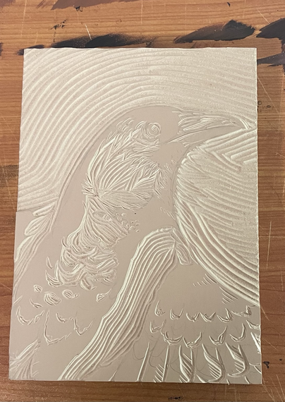 Fully carved linoleum block with a magpie, un-inked.