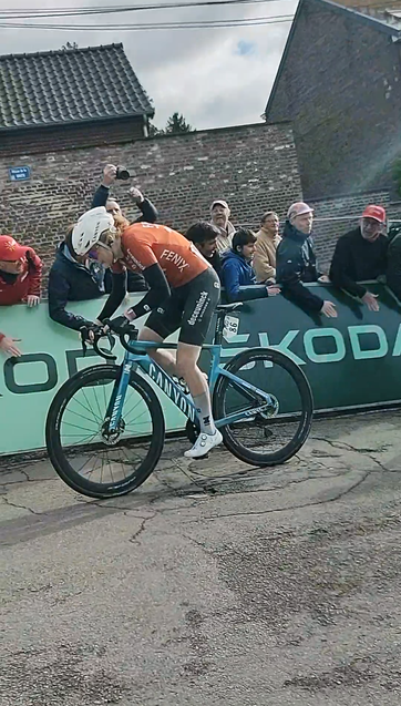 Female cyclist standing on the pedals on a steep climb.