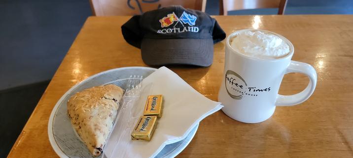 Bacon Cheddar Scone with a Hazelniccino.
My Scotland flags ballcap is on the table.