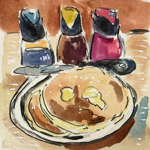 A plate of two buttermilk pancakes with melting butter. A butter knife rests across the edge of the plate. Behind the plate are three flavoured and colourul bottles of syrup: blue berry, apricot, and strawberry.