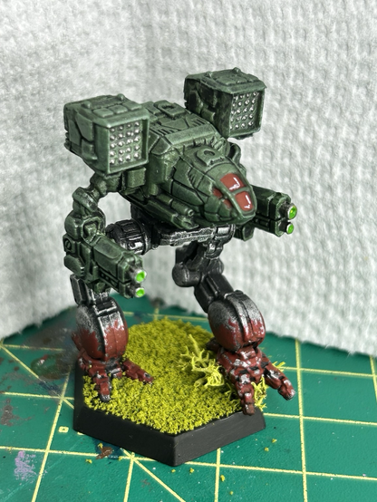 a Timberwolf mech, painted with a green torso and red paint splashed on the feet