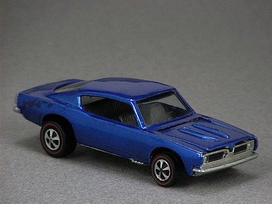 Released in 1968, Spectraflame Pink Custom Barracuda of 1968 Hot Wheels with Redline wheels. Notes: HK casting has longer hood scoops and larger black steering wheel. Packaging: 1968 Blister. Metal Body, Metal Base. Made in Hong Kong. Scarcity: 8-10/10