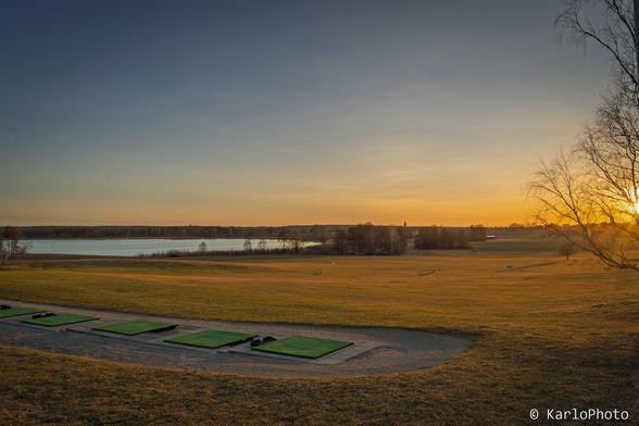 A sunset over a golf course.