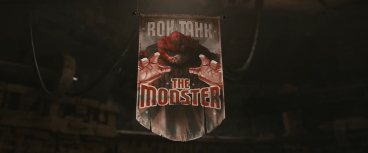 A banner hanging above a fighting arena showing "Rok-Tahk The Monster" along with a picture of a ferocious Rok.  From E116