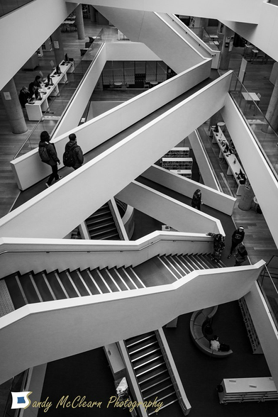 Crisscrossing staircases and bridges inside a building.