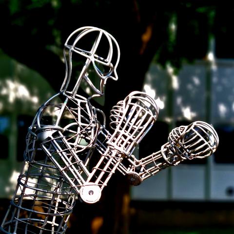 A metal wire-frame sulpture of a boxer.