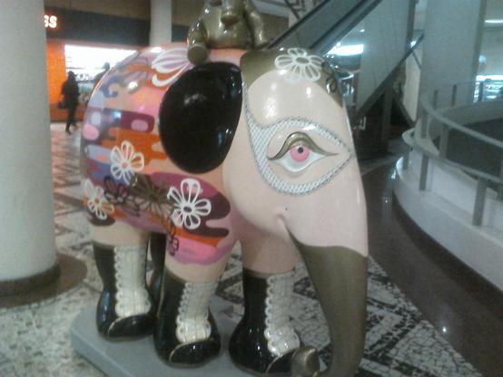 Na imagem, um elefante de resina colorido em tons rosados