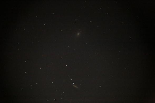 A picture of M81 and M82 galaxies, white smudges in a field of stars. Taken via pingu camera.