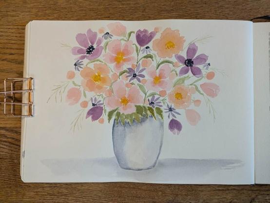 This is a watercolor painting of flowers in a vase. The flowers are peachy pink, peach, pinky purple, and bluish purple with some yellowish green leaves and greenery. Some of the flowers are open others are buds. Some of the floral centers are a warm yellow some are dark blue.