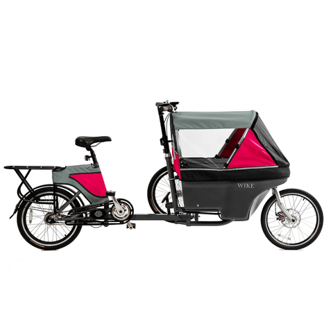 A mostly normal looking long-john-/bakfiets-style cargo bike with an odd third wheel mounted on the left side so that its tire is above the bottom frame tube of the cargo bike. It has a canopy in grey and pink with windows all around. Profile view from the right side.