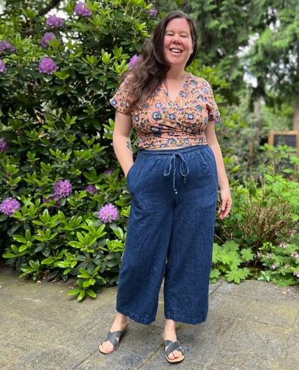 Helen wears wide leg elastic waist denim pants with a block print wrap top.⁠