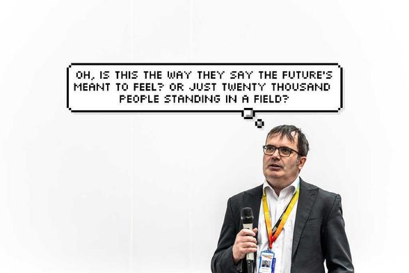 The same bloke but with a preemptive thought  bubble with Pulp lyrics "Oh, is this the way they say the future's meant to feel? Or just twenty thousand people standing in a field?"