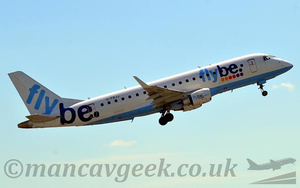Side view of a white, twin engined jet airliner flying from left to right at a very low altitude, with it's undercarriage still lowered, flaps extended from the rear of the wing, and the nose raised sharply, suggesting it has just taken off.
The plane is almost all white, with a pale blue belly.
There are large, blue "FlyBe" titles on the forward fuselage, over 6 coloured dots - 2 orange, 2 red, 2 purple.
The same logo is on the white engine pods under the wing - the word "FlyBe" over 6 coloured dots, only this time with "[dot]com" added at the end.
The word "FlyBe" also appears on the tail and rear fuselage.
The registration "G-FBJJ" is on the upper rear fuselage in black.
Pale blue sky fills the rest of the frame.