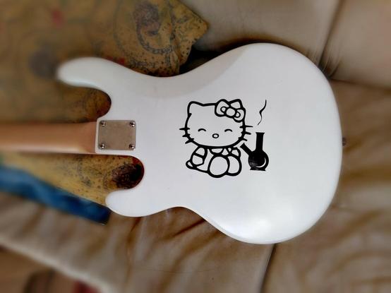 The back of Hello Kitty features artwork of Hello Kitty smoking a bong.