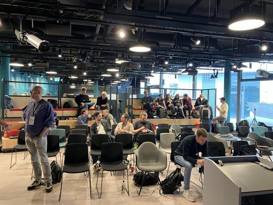 Some people sitting in the audience of the conference room
