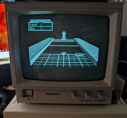 Shufflepuck Cafe on a monochrome surveillance monitor sitting atop an Apple IIgs