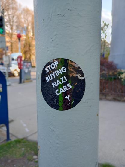 Decal on pole, which says 
Stop buying Nazi cars