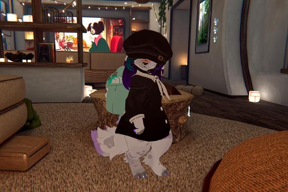 The photo shows an anime-style furry character, wearing a dark-colored coat and a newsboy cap, standing in a living room. The character appears to be in a virtual environment, possibly a video game. A television showing an anime is visible in the background. The character is positioned near a low, tree-trunk-shaped table.