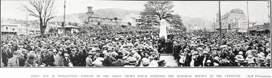 Black-and-white photo: Anzac Day in Wellington: Portion of the Great Crowd Which Attended the Memorial Service at the Cenotaph. 1925. Description: Shows a large crowd of formally dressed men, women and children standing around the temporary wood-and-plaster cenotaph. It was located on the grass triangle at the junction of Molesworth Street and Lambton Quay, part of Parliament grounds at the time. Citation: Supplement to the Auckland Weekly News, 30 April 1925, p. 46. Auckland Libraries Heritage Collections AWNS-19250430-46-01. https://kura.aucklandlibraries.govt.nz/digital/collection/photos/id/244150