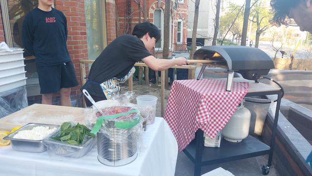 Making the pizza in the gas-fired oven on the porch.