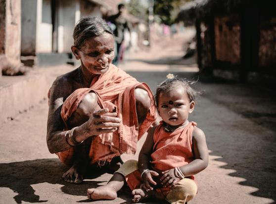 mother and baby sitting on the ground