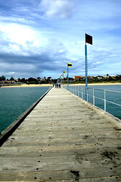 wooden pier, looking back, town view, Frankston, beach, holiday town, cloudy sky, flags, wide angle view,