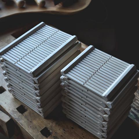 Image of two piles of rigid heddles.
